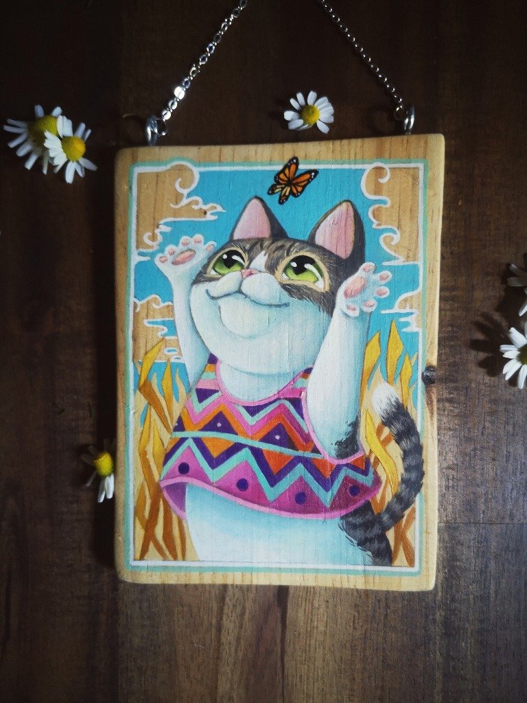 Gato jugando con mariposa